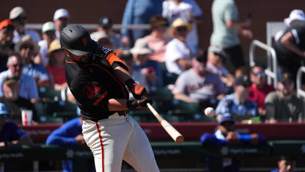 Mar 1, 2024; Scottsdale, Arizona, USA; San Francisco Giants first baseman J.D. Davis (7) hits a home run against the Texas Rangers during the second inning at Scottsdale Stadium.